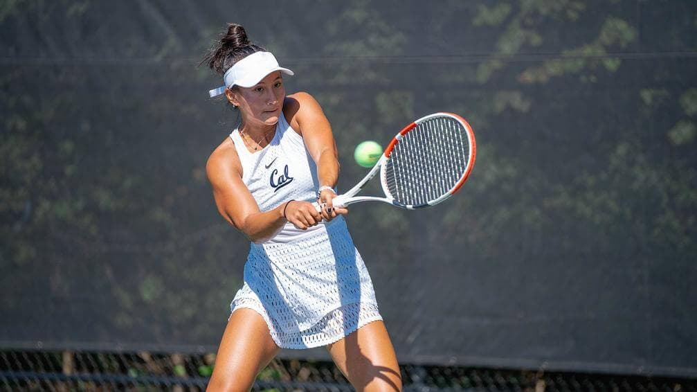 College tennis player in a Cal uniform hitting a backhand